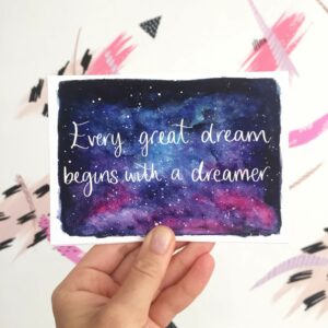 Postcard with quote written on night sky watercolour: 'Every great dream begins with a dreamer'