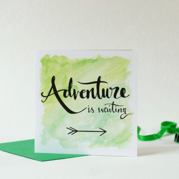 Green card with hand lettered text 'Adventure is waiting' and illustrated arrow