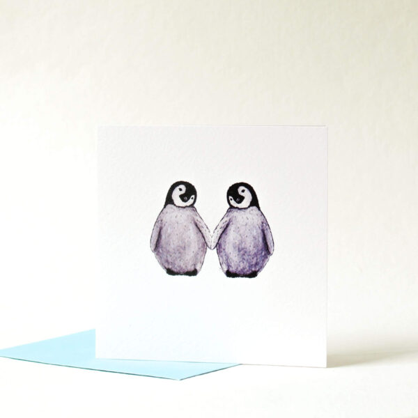 Printed card - two cute fluffy penguins holding flippers