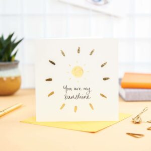 Pretty desk featuring 'you are my sunshine' card with sunshine design and gold foil detail