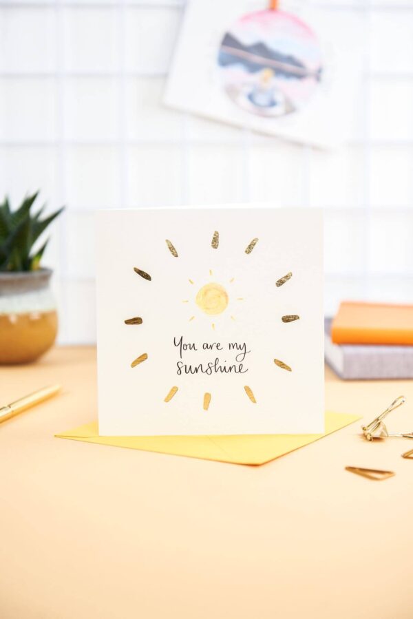 Pretty desk featuring 'you are my sunshine' card with sunshine design and gold foil detail