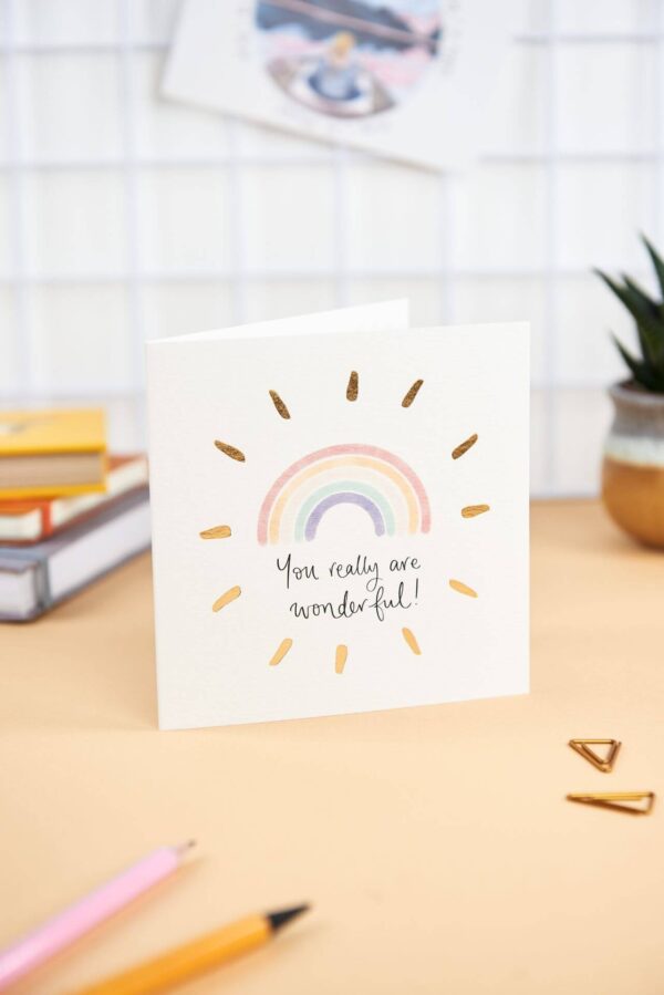 Pretty desk featuring 'you really are wonderful' card with rainbow design and gold foil detail