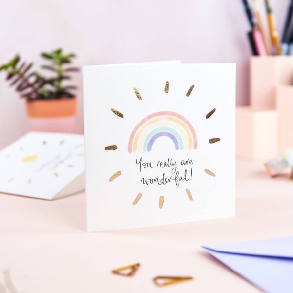 Pretty pink desk featuring 'you really are wonderful' rainbow card