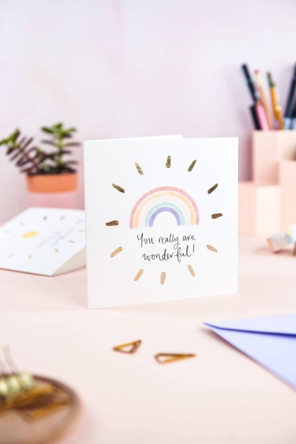 Pretty pink desk featuring 'you really are wonderful' rainbow card