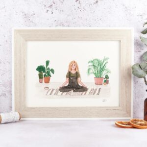 framed art print of a girl calmly meditating surrounded by house plants.