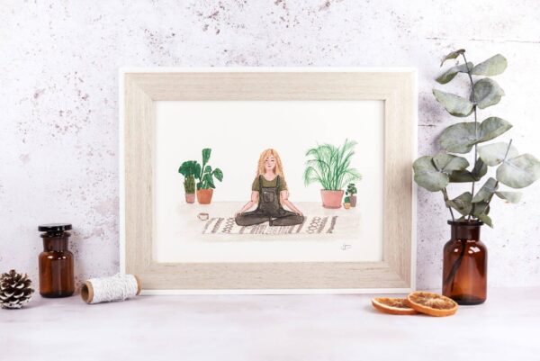 framed art print of a girl calmly meditating surrounded by house plants.