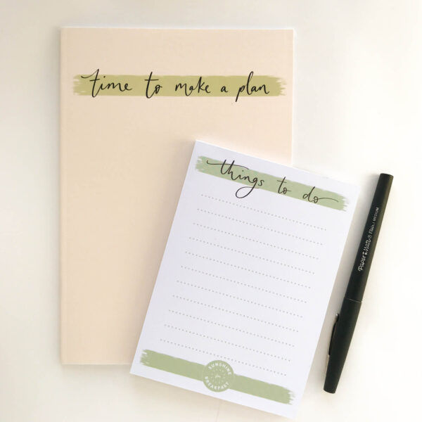 'Things to do' notepad, on top of a 'time to make a plan' notebook