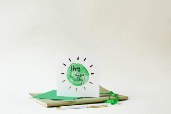 Card reads 'Happy Father's Day!' with green circular design and gold foil detail