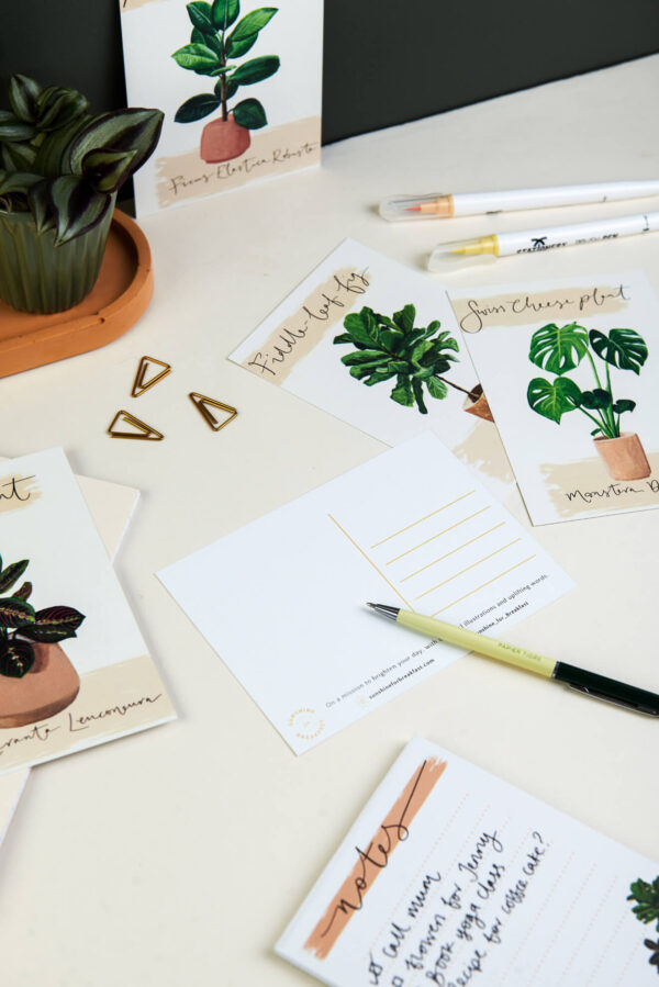 Desk set up ready to write on illustrated house plant postcards