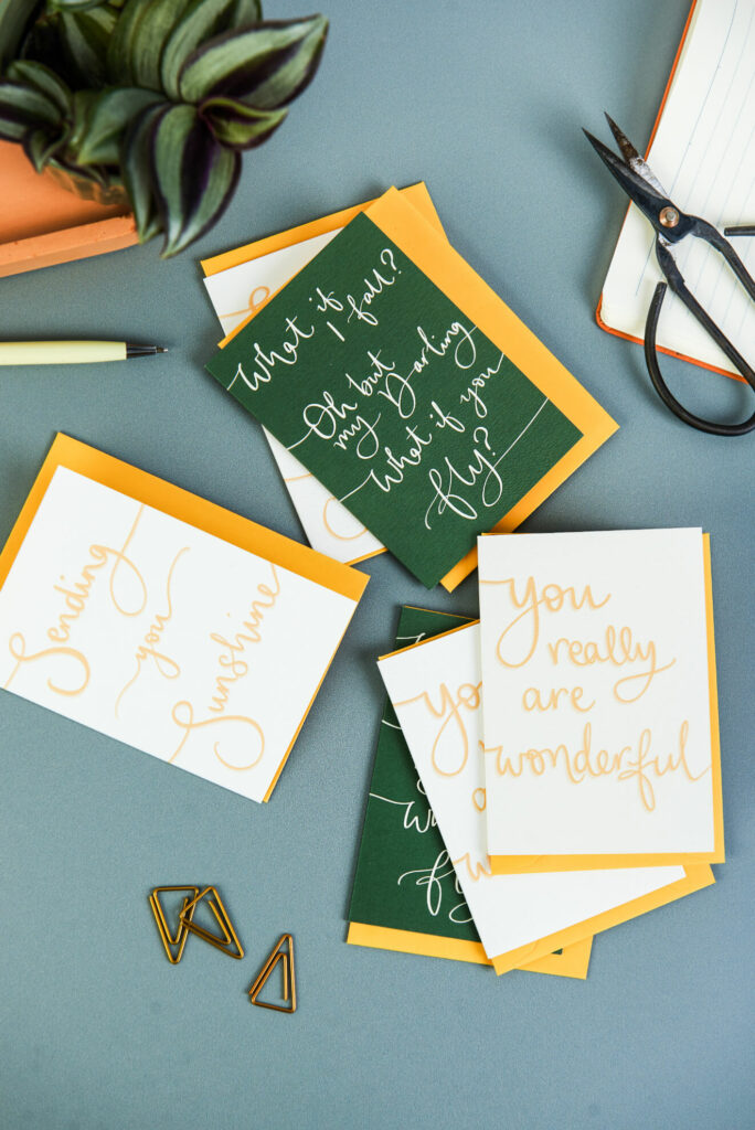 positive mini notecards scattered on a desk