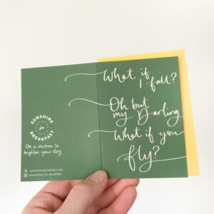 what if you fly mini notecard, held displaying the detail of hand lettered text that flows from the front to back of the card