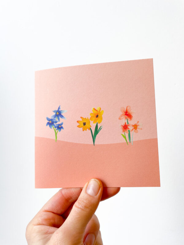 hand holding flowers card with pink pattern