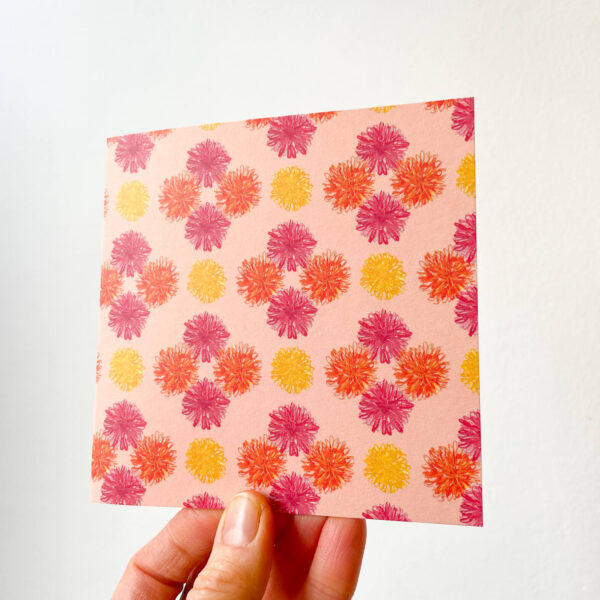 hand holding card with bold pink floral pattern